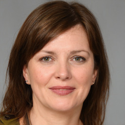 Joyful white adult female with medium  brown hair and grey eyes