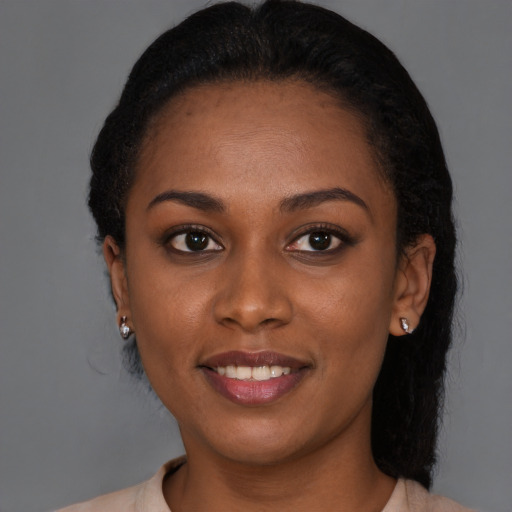 Joyful black young-adult female with medium  brown hair and brown eyes