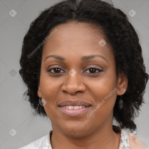 Joyful black adult female with medium  brown hair and brown eyes