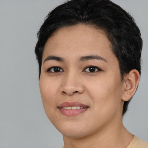 Joyful asian young-adult female with medium  black hair and brown eyes
