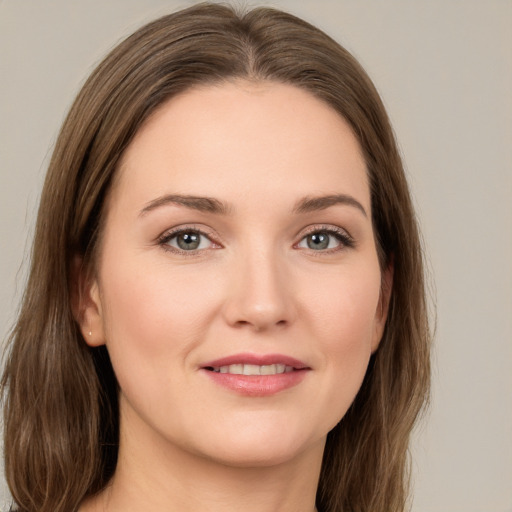 Joyful white young-adult female with long  brown hair and grey eyes