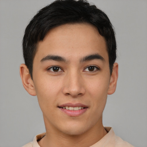 Joyful asian young-adult male with short  brown hair and brown eyes