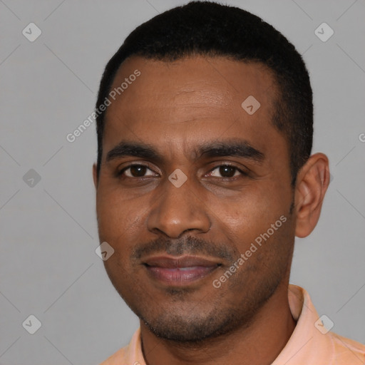 Joyful black young-adult male with short  black hair and brown eyes