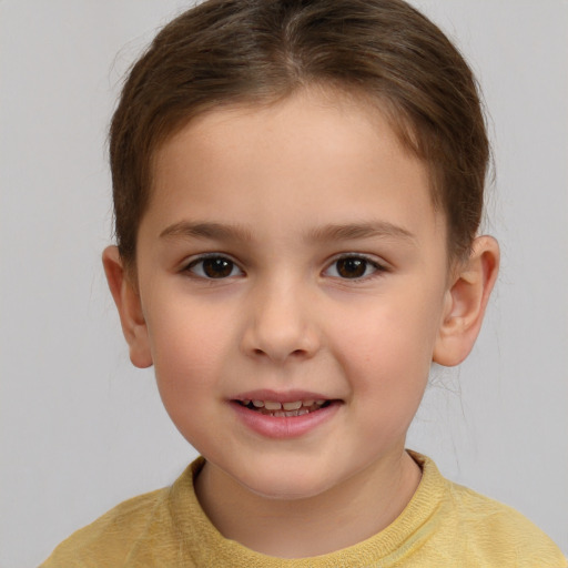 Joyful white child female with short  brown hair and brown eyes