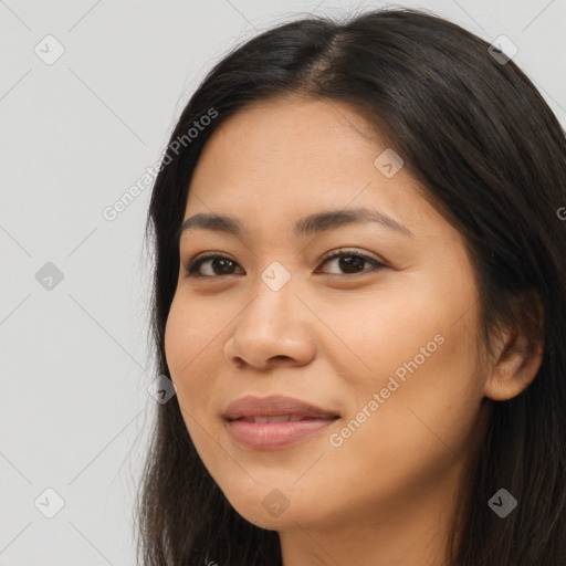 Joyful latino young-adult female with long  brown hair and brown eyes