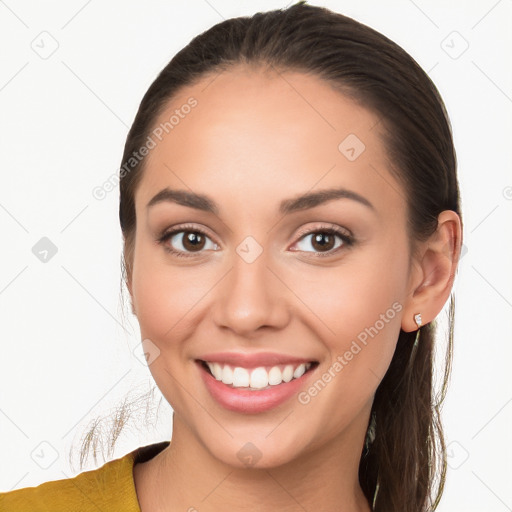 Joyful white young-adult female with long  brown hair and brown eyes