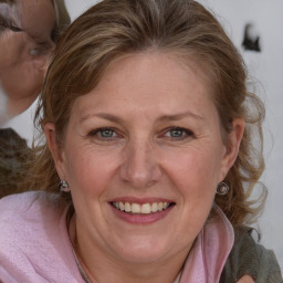 Joyful white adult female with medium  brown hair and blue eyes