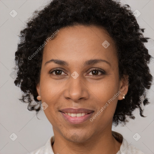 Joyful black adult female with short  brown hair and brown eyes