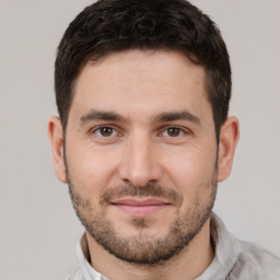 Joyful white young-adult male with short  brown hair and brown eyes