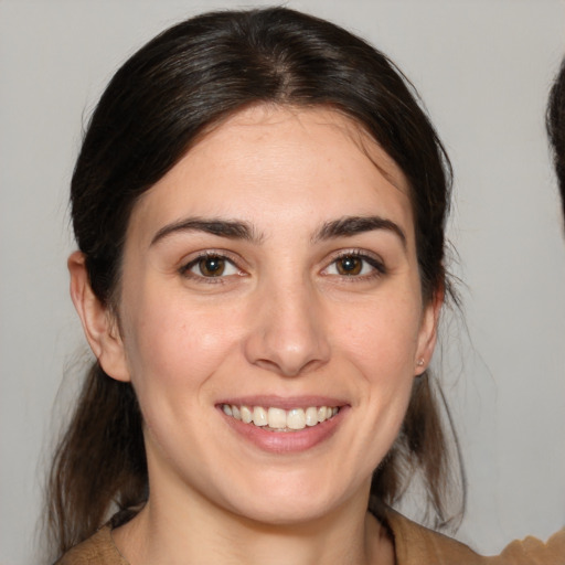 Joyful white young-adult female with medium  brown hair and brown eyes