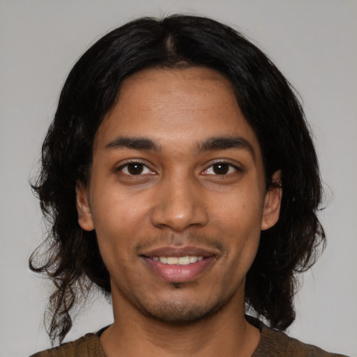 Joyful latino young-adult male with medium  black hair and brown eyes