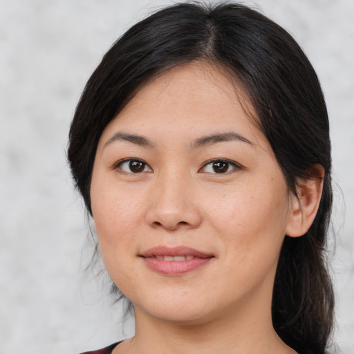 Joyful asian young-adult female with medium  brown hair and brown eyes