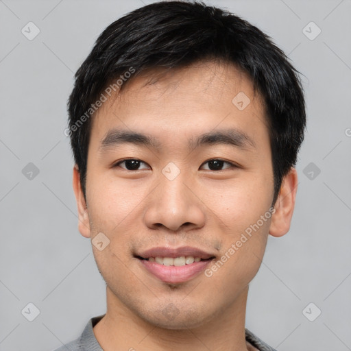 Joyful asian young-adult male with short  black hair and brown eyes