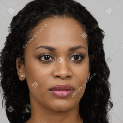 Joyful black young-adult female with long  brown hair and brown eyes