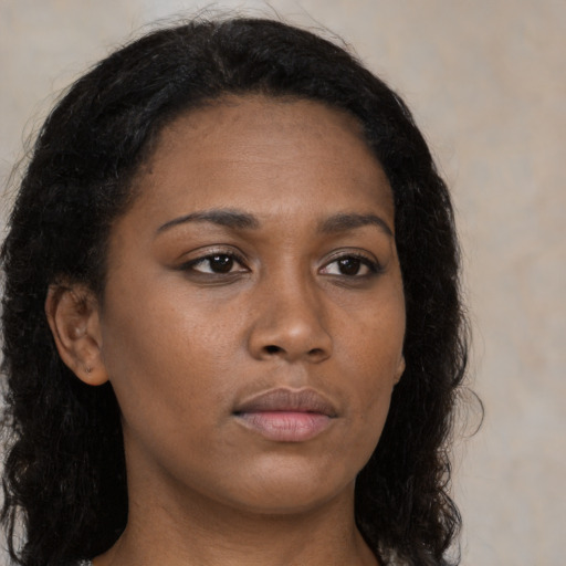 Neutral black young-adult female with long  brown hair and brown eyes