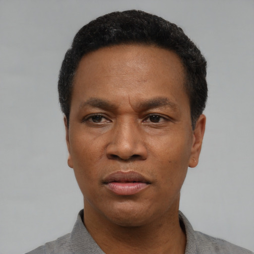 Neutral black adult male with short  black hair and brown eyes