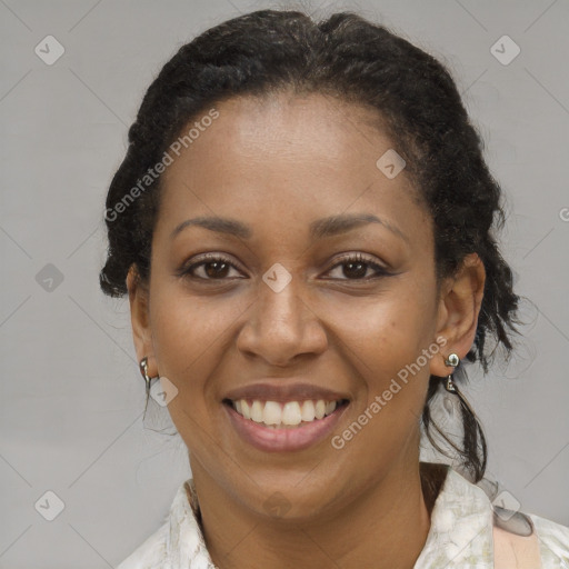 Joyful black adult female with medium  brown hair and brown eyes