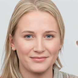 Joyful white young-adult female with medium  brown hair and blue eyes