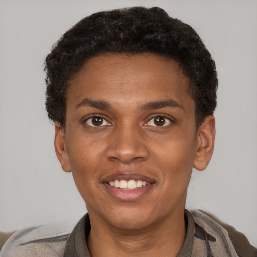 Joyful black young-adult female with short  brown hair and brown eyes