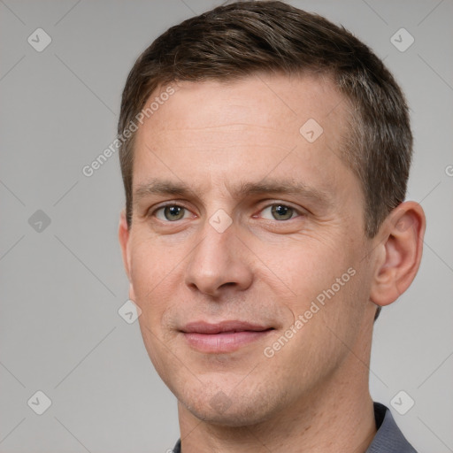 Joyful white adult male with short  brown hair and grey eyes