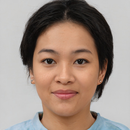 Joyful asian young-adult female with medium  brown hair and brown eyes