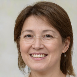 Joyful white adult female with medium  brown hair and brown eyes