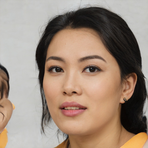 Joyful asian young-adult female with medium  black hair and brown eyes