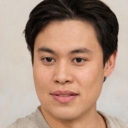 Joyful asian young-adult male with short  brown hair and brown eyes