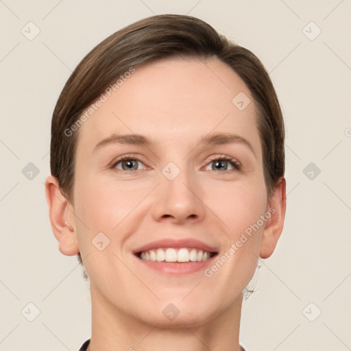 Joyful white young-adult female with short  brown hair and grey eyes