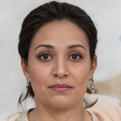 Joyful white adult female with medium  brown hair and brown eyes