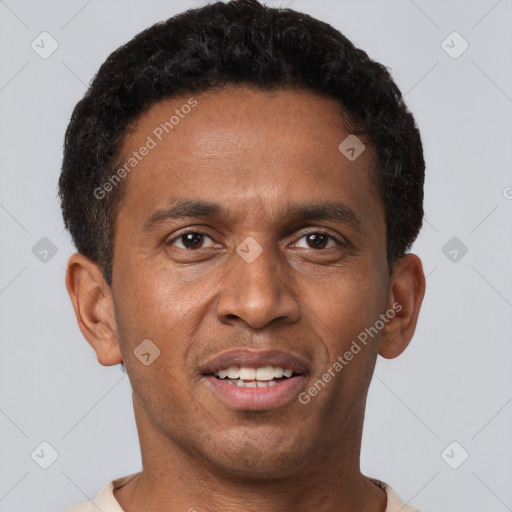 Joyful black young-adult male with short  brown hair and brown eyes