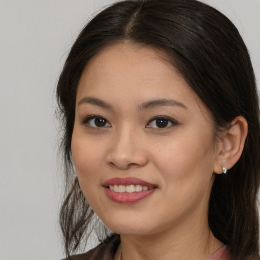 Joyful asian young-adult female with long  brown hair and brown eyes