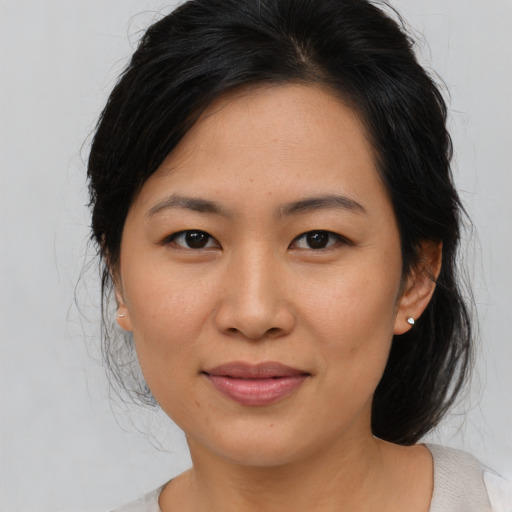 Joyful asian young-adult female with medium  brown hair and brown eyes