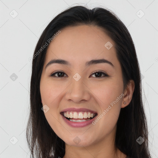 Joyful white young-adult female with long  brown hair and brown eyes