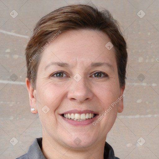 Joyful white adult female with short  brown hair and grey eyes