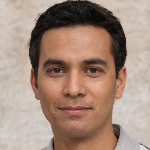 Joyful white young-adult male with short  black hair and brown eyes