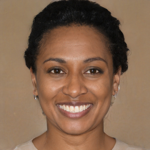 Joyful black young-adult female with short  brown hair and brown eyes