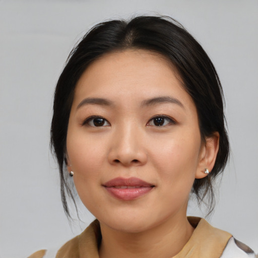 Joyful asian young-adult female with medium  brown hair and brown eyes