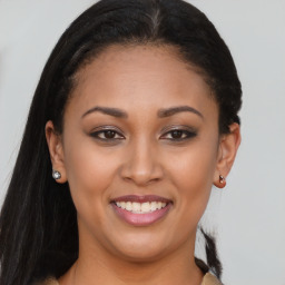 Joyful latino young-adult female with long  brown hair and brown eyes