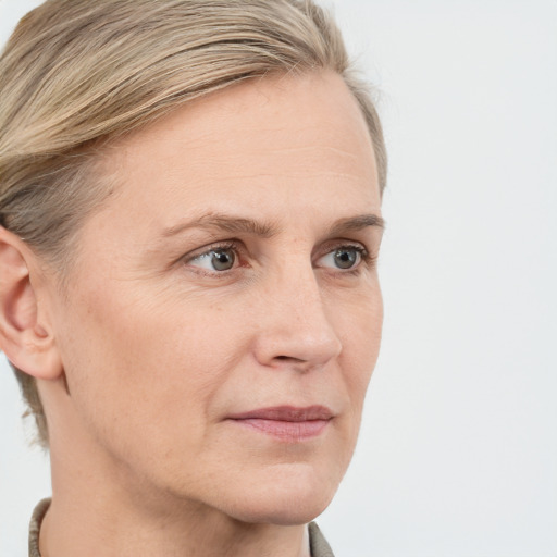 Joyful white adult female with short  brown hair and blue eyes