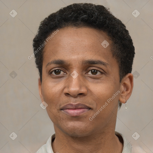 Joyful black adult male with short  black hair and brown eyes