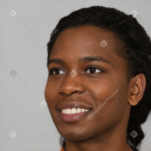 Joyful black young-adult female with short  black hair and brown eyes