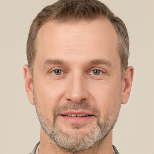 Joyful white adult male with short  brown hair and brown eyes