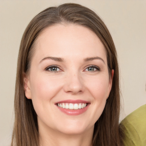 Joyful white young-adult female with long  brown hair and grey eyes