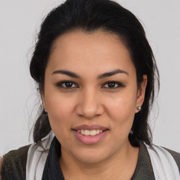 Joyful latino young-adult female with long  brown hair and brown eyes