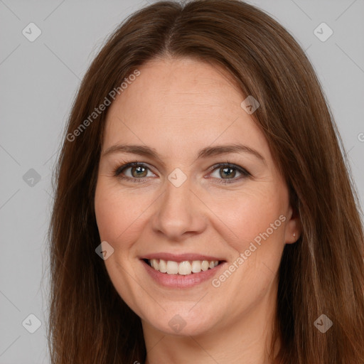 Joyful white adult female with long  brown hair and brown eyes