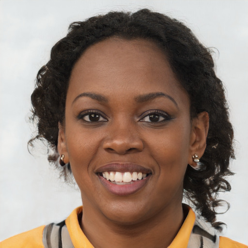 Joyful black young-adult female with short  brown hair and brown eyes