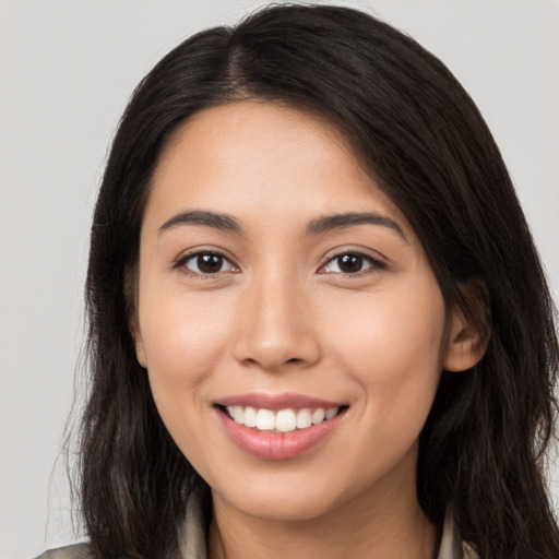 Joyful white young-adult female with long  brown hair and brown eyes