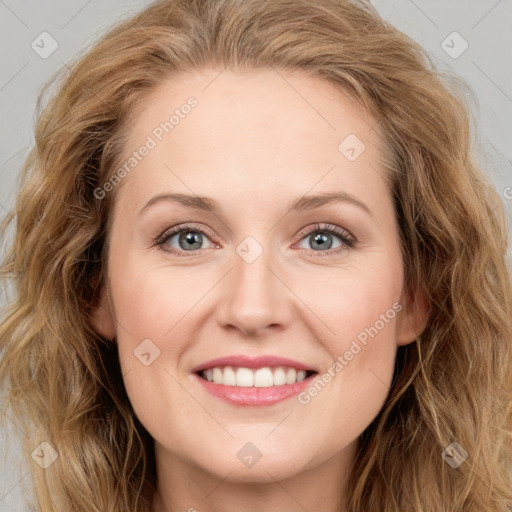 Joyful white young-adult female with long  brown hair and blue eyes