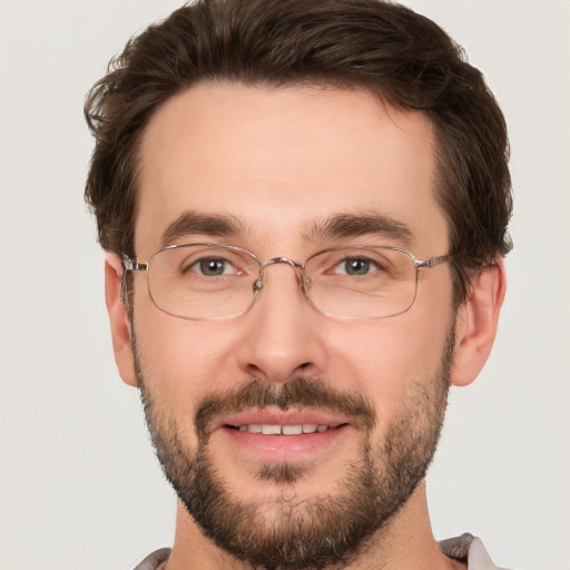 Joyful white adult male with short  brown hair and brown eyes